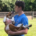 Man holding a small dog