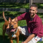 Great Valley employee posing with a dog